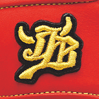 Close-up of an embroidered yellow and black Chinese character on red fabric, WAGYU JB Baseball Glove Hard Ball Pitcher JB-J001. Wagyu JB